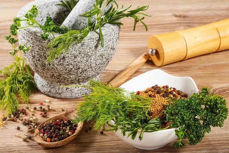 A table with herbs and spices in bowls