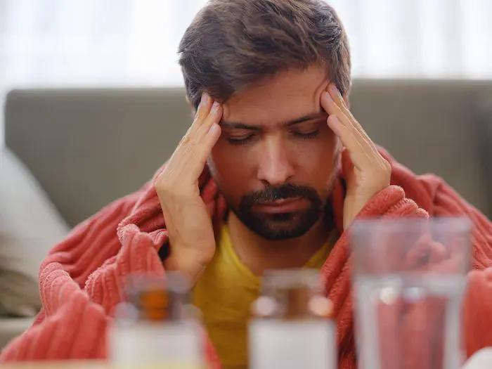 A man with his head in his hands.