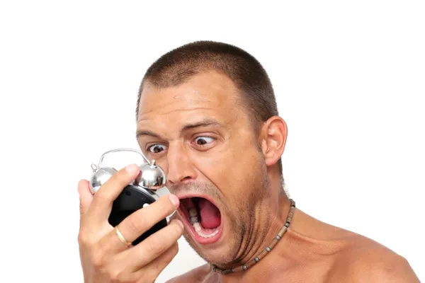 A man holding a camera up to his mouth.