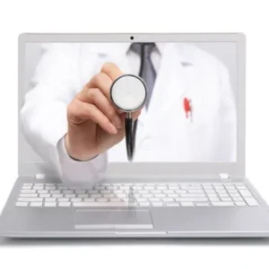 A person holding up a stethoscope in front of a laptop.