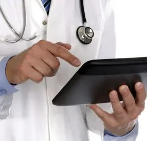 A doctor is using his tablet computer.